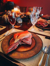 a plate with a bow tie and glasses of wine on it