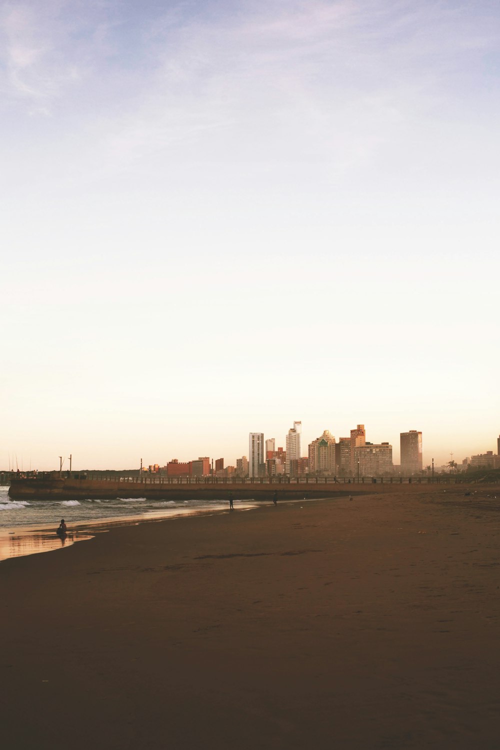 a beach with a city in the background
