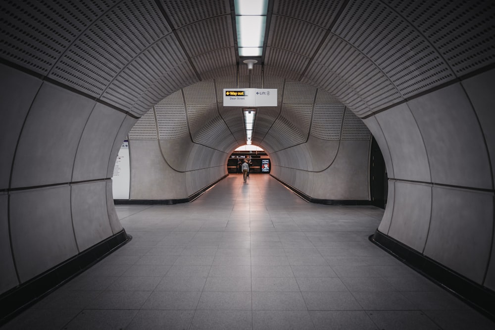 a person walking down a tunnel