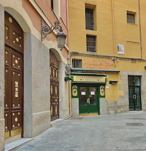 A warm, inviting storefront of a local Cádiz shop with Jesús Sánchez González greeting customers.