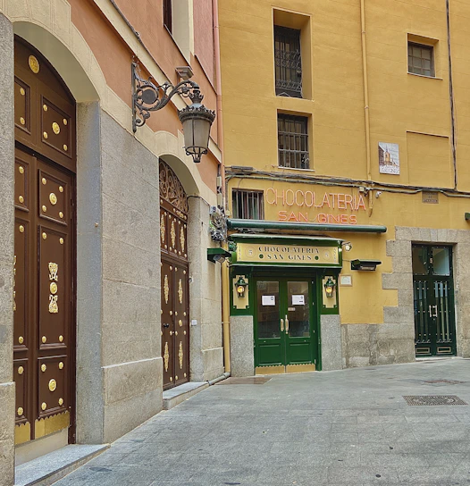 A warm, inviting storefront of a local Cádiz shop with Jesús Sánchez González greeting customers.