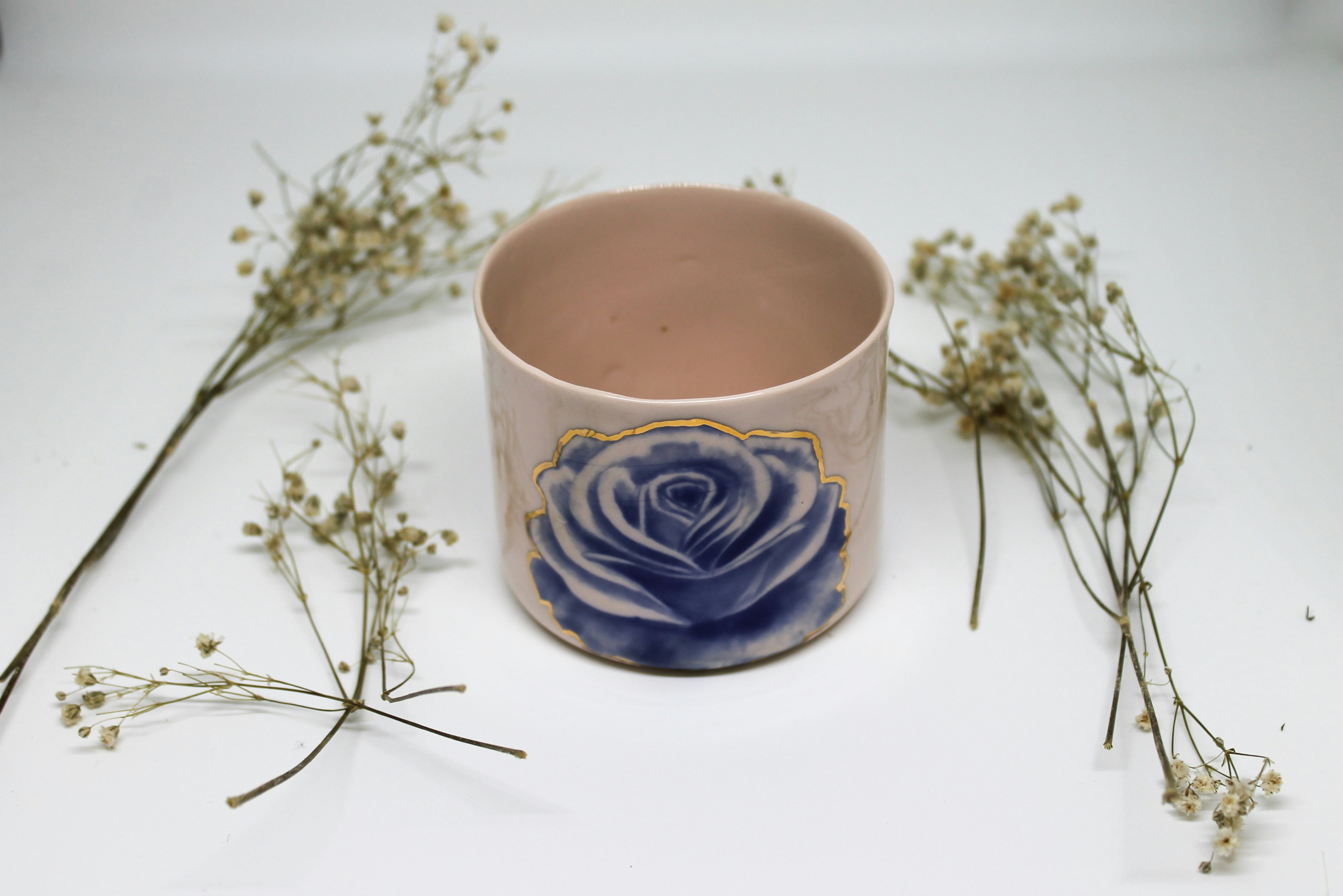 a cup with a flower in it