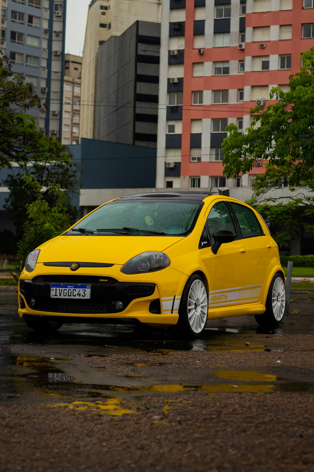 a yellow car parked in front of a building