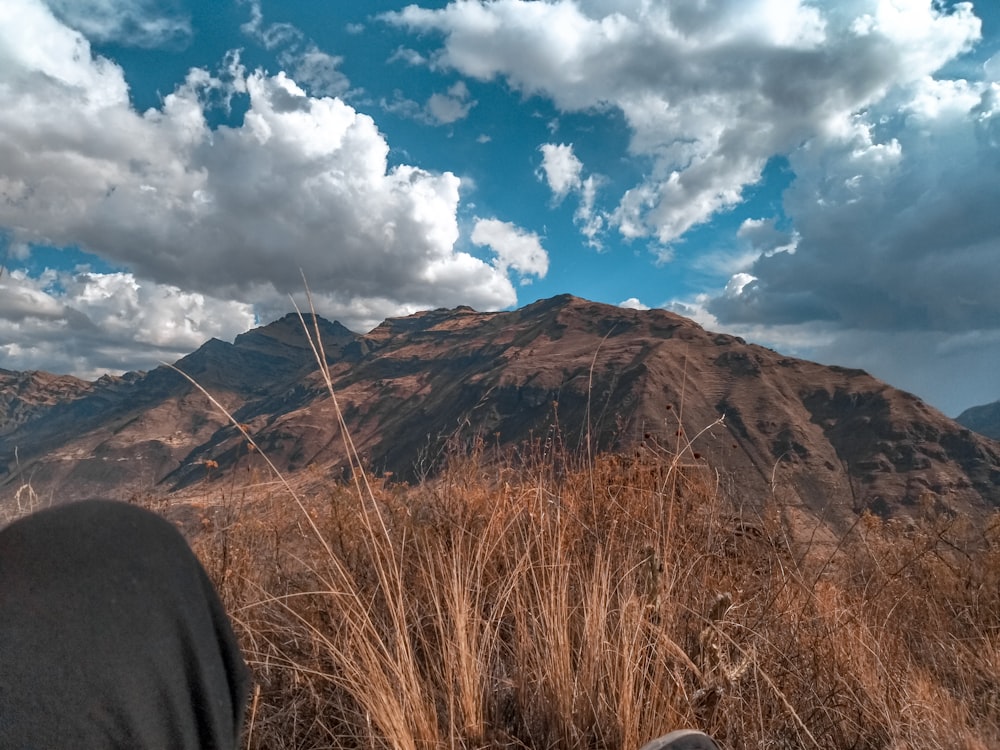 a view of a mountain range from a person's feet