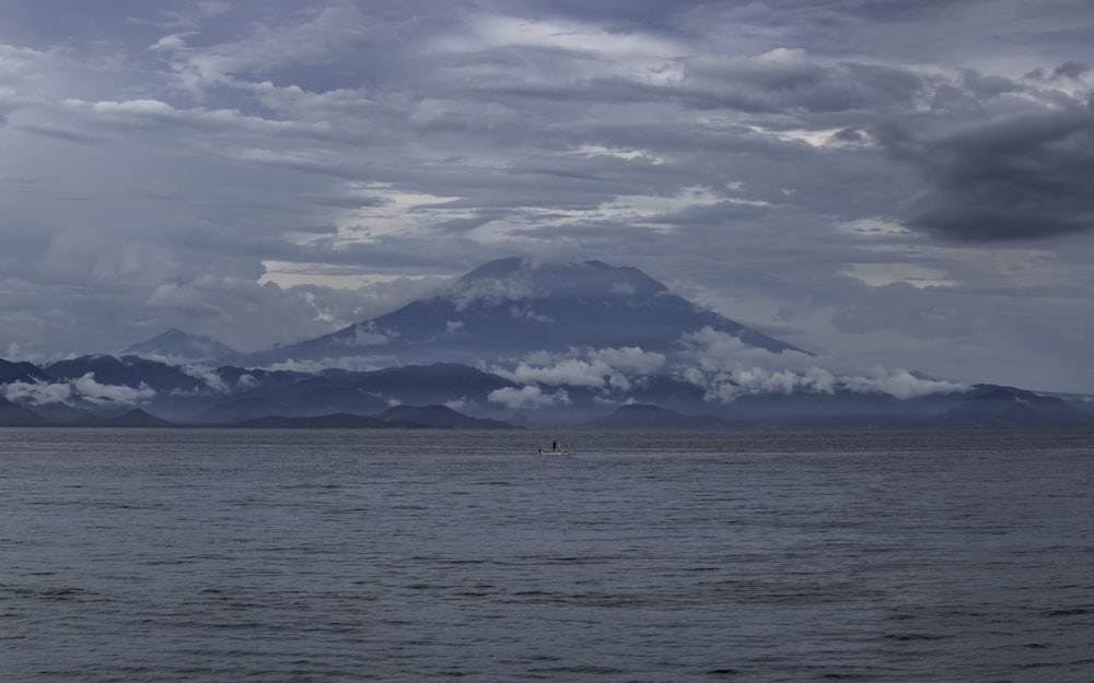 a body of water with mountains in the background