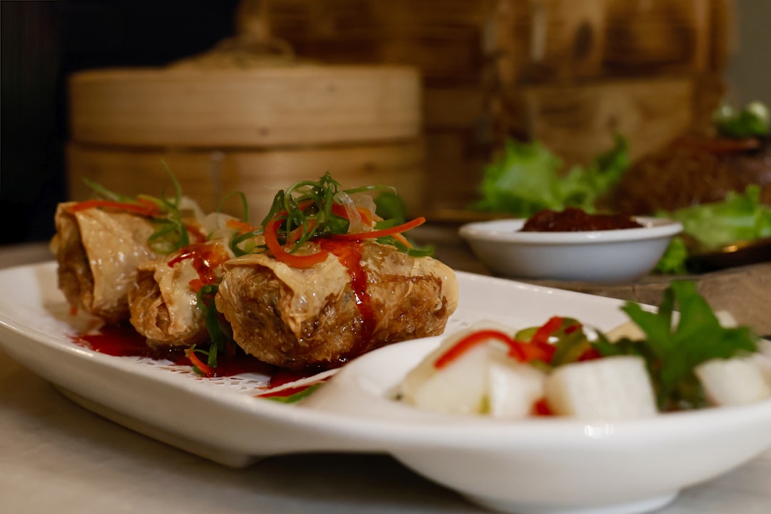 a plate of food, Spring rolls served with herbs and marinated radish