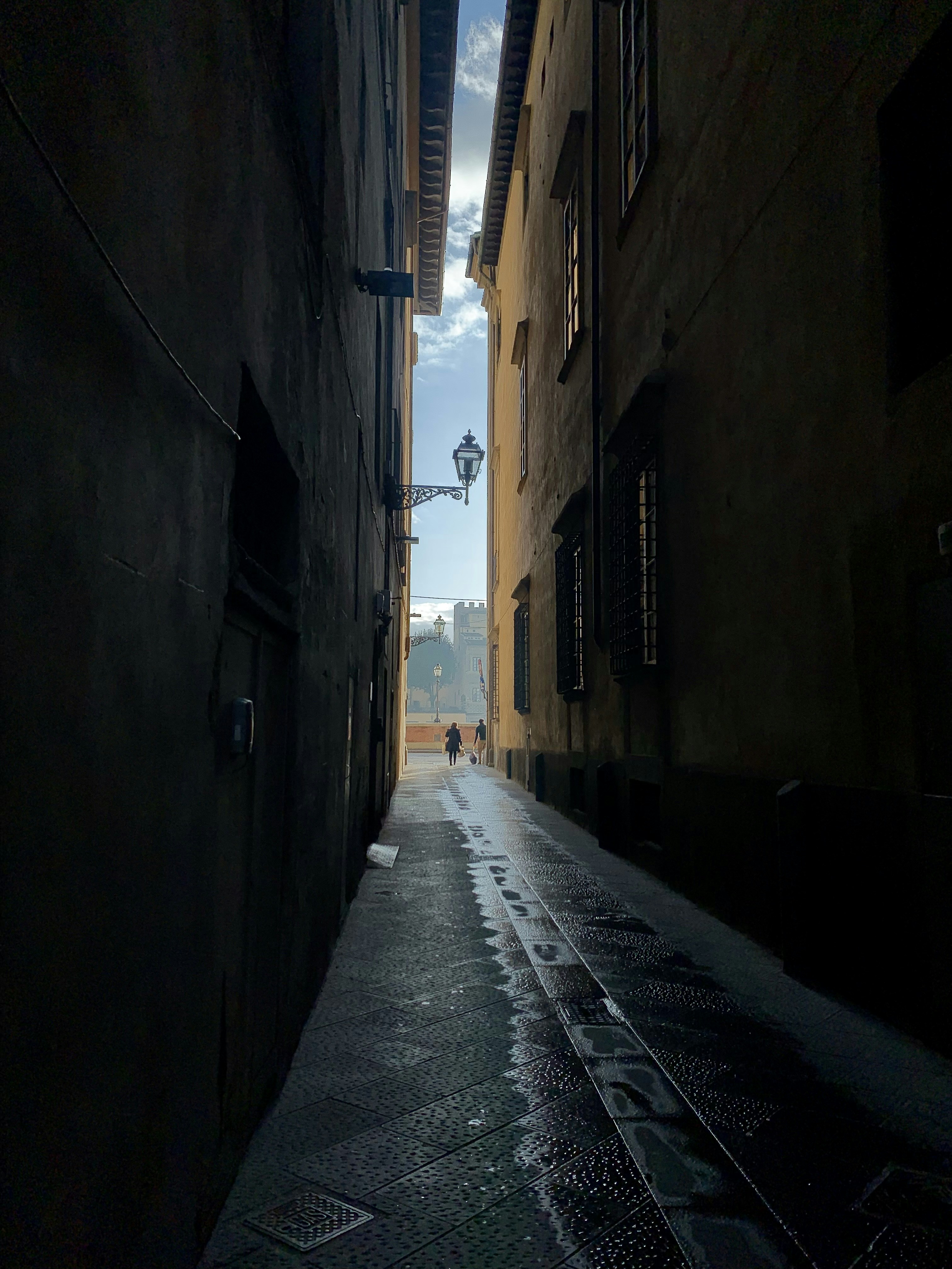a person walking down a narrow street