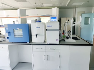 a room with white cabinets and blue cabinets