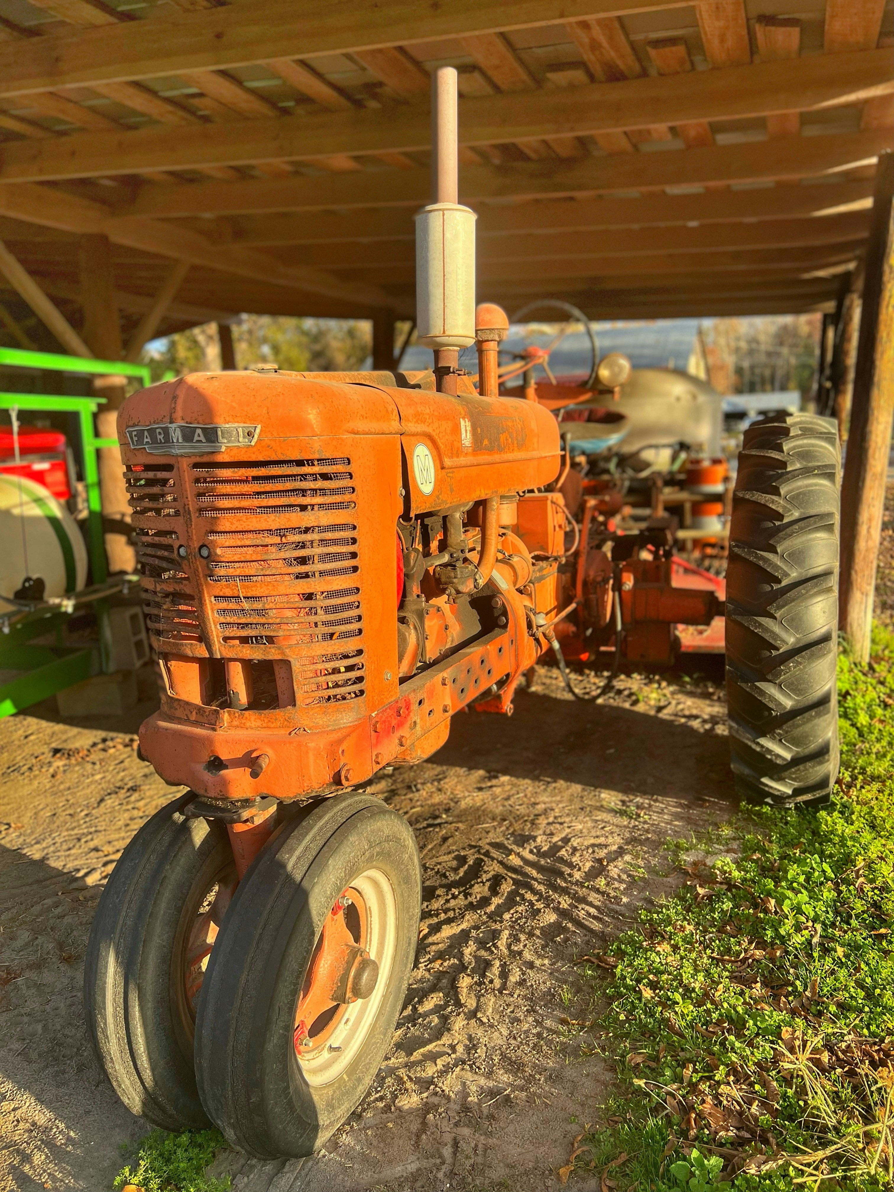 A modern red tractor in a green field.