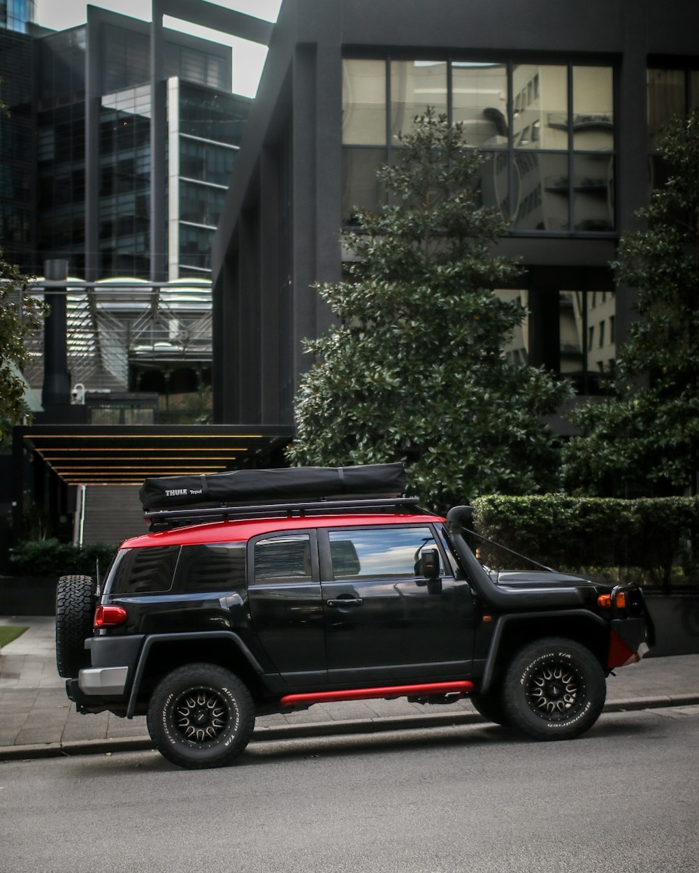 a black pickup truck parked in front of a building