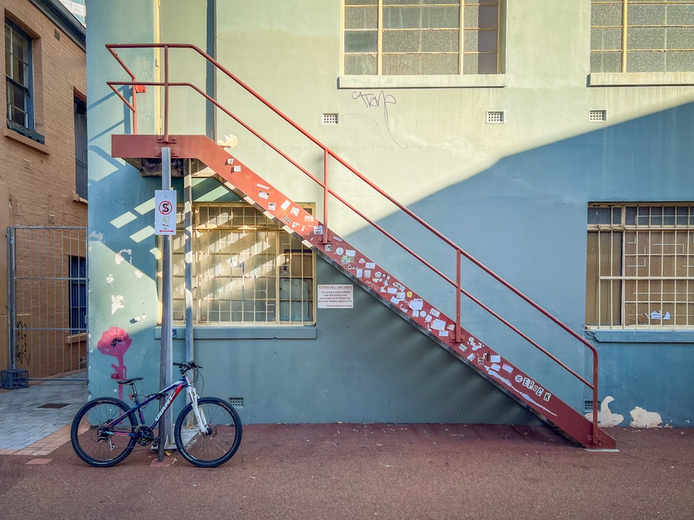 a bicycle parked next to a building