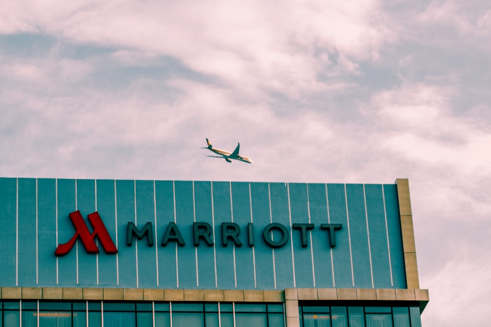 an airplane flying over a building