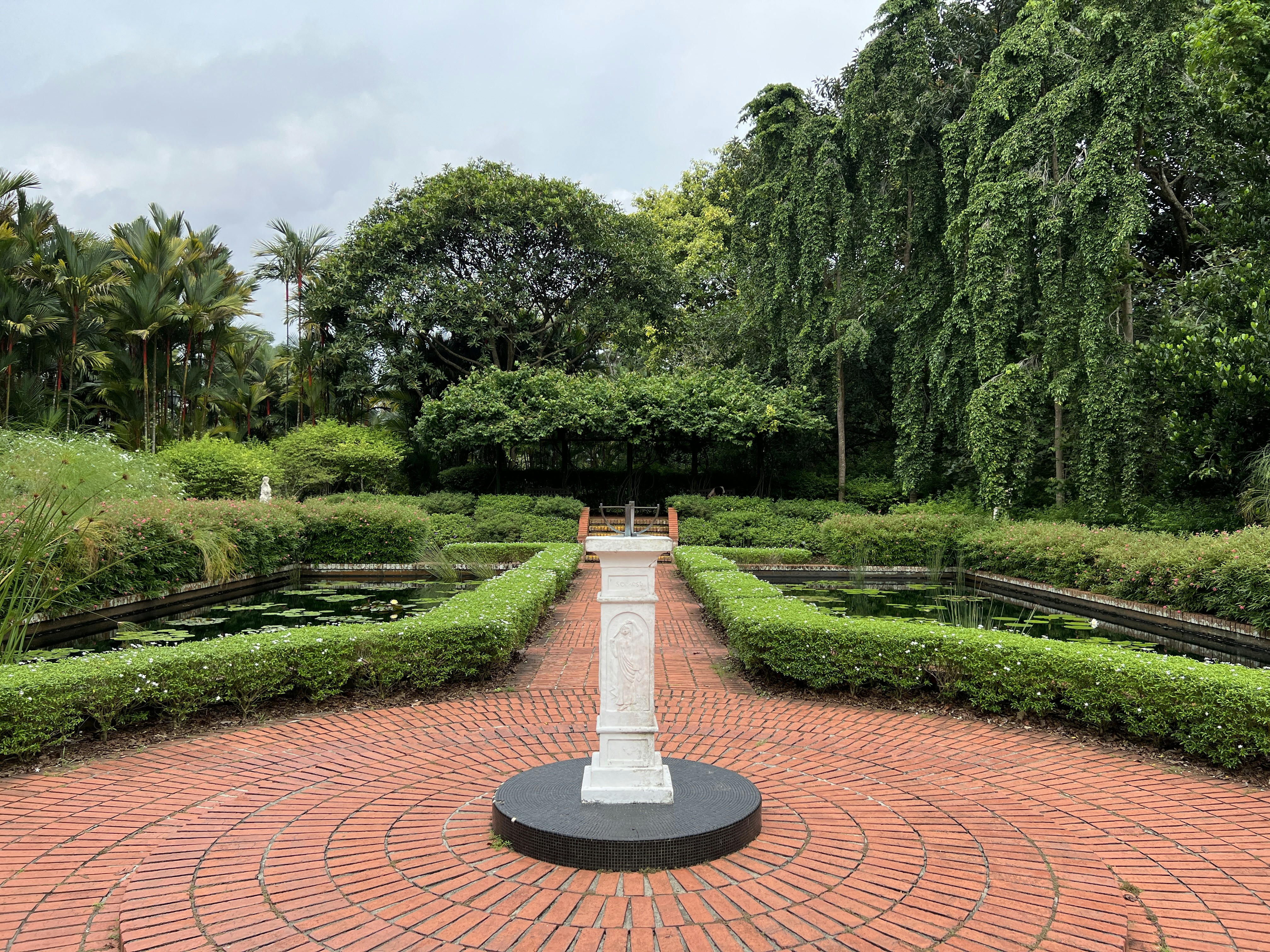 A well-balanced garden with a clear focal point like a statue or unique tree. - backyard landscape design