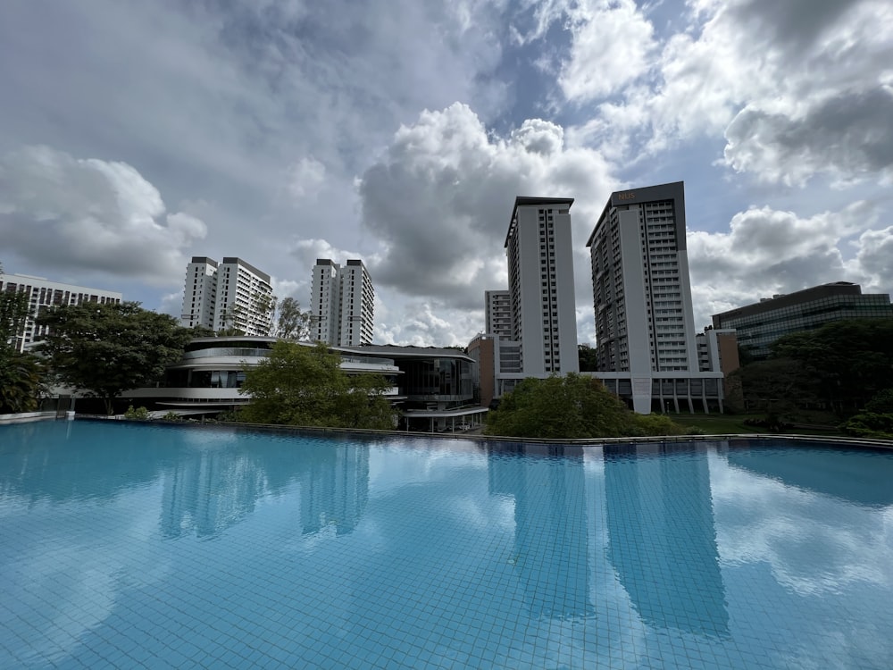 a body of water with buildings in the background