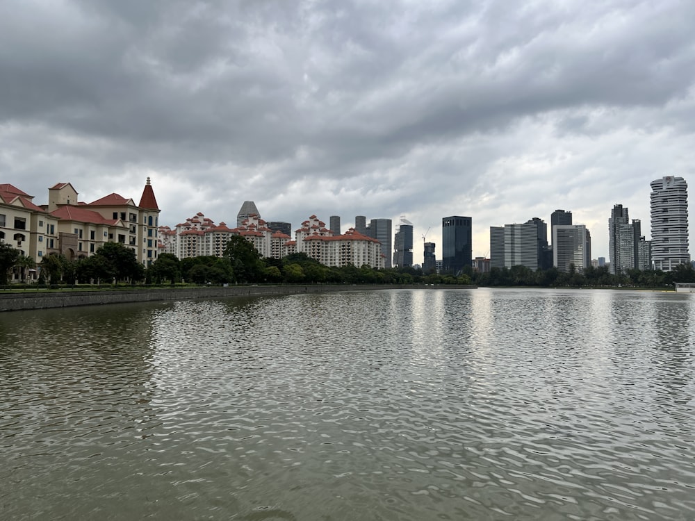 a body of water with buildings in the background