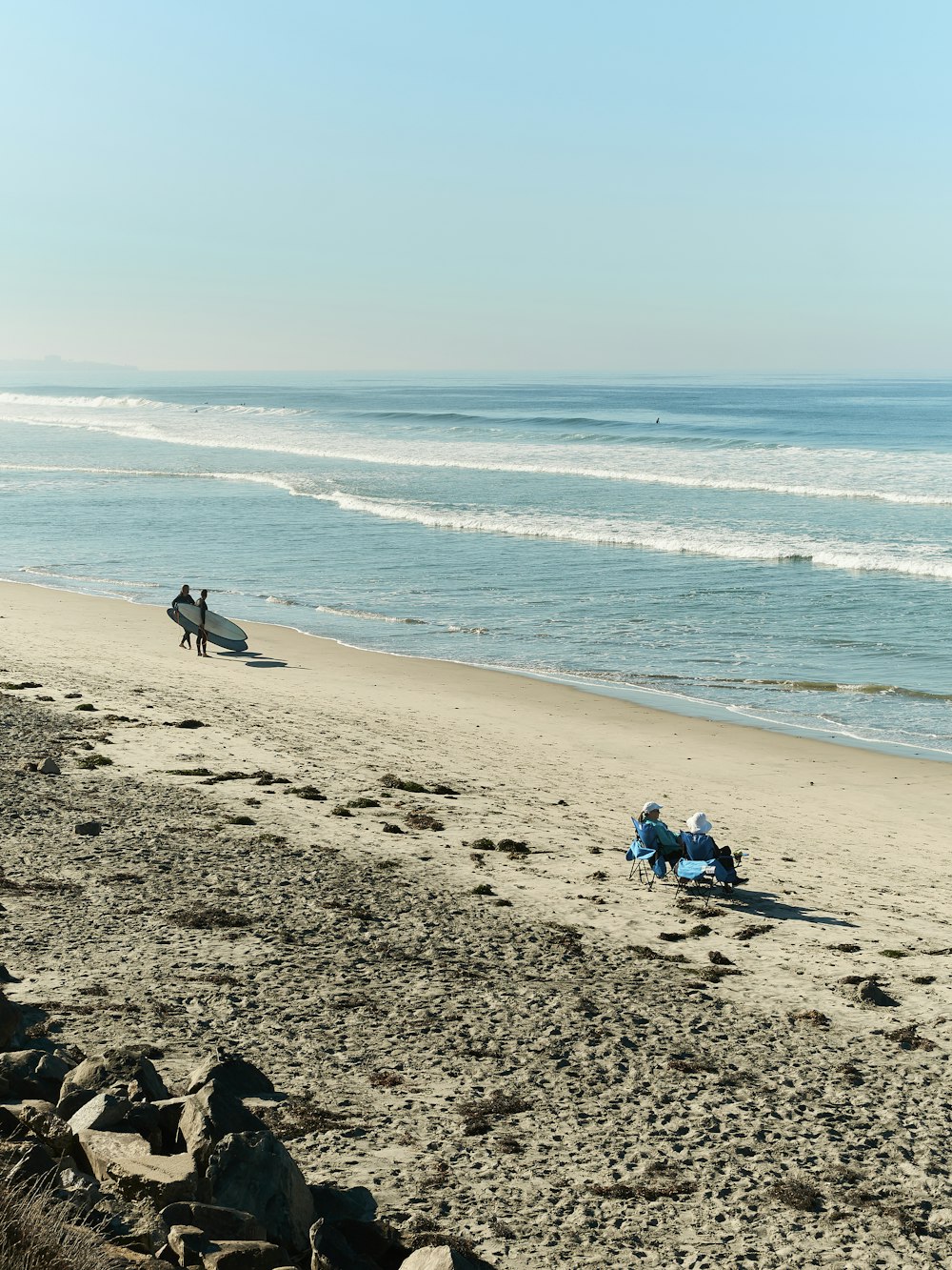 a group of people sitting on a beach