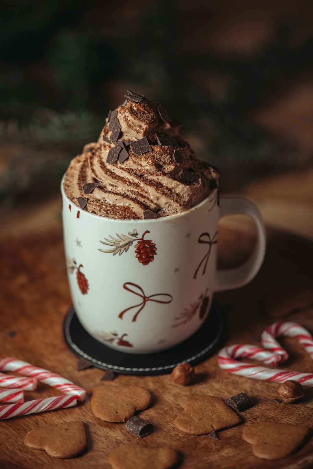 a cup of coffee with a cookie on top