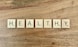 a group of white boxes with black text on a wooden surface