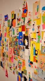 A vibrant collage of colorful photographs pinned on a wall.