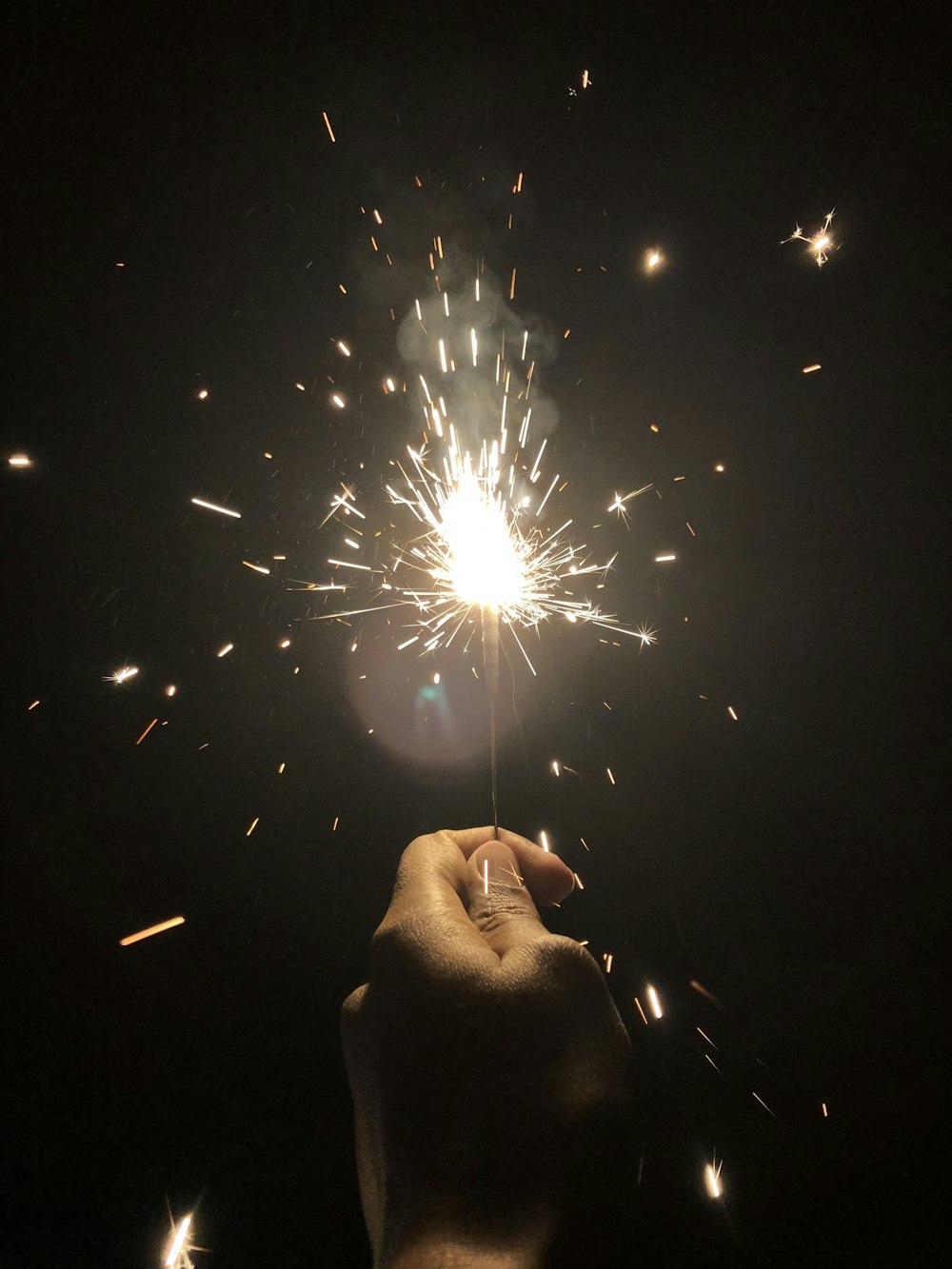 a person holding a sparkler