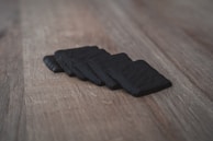 Finished physical products arranged artfully on a black surface, highlighting their textures and forms.