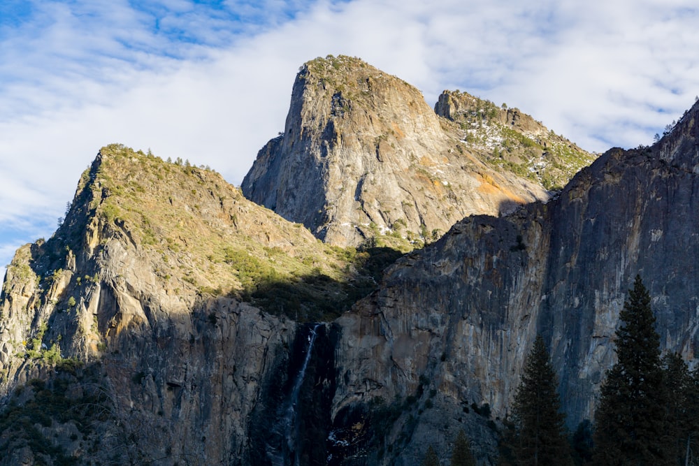 a rocky mountain with trees