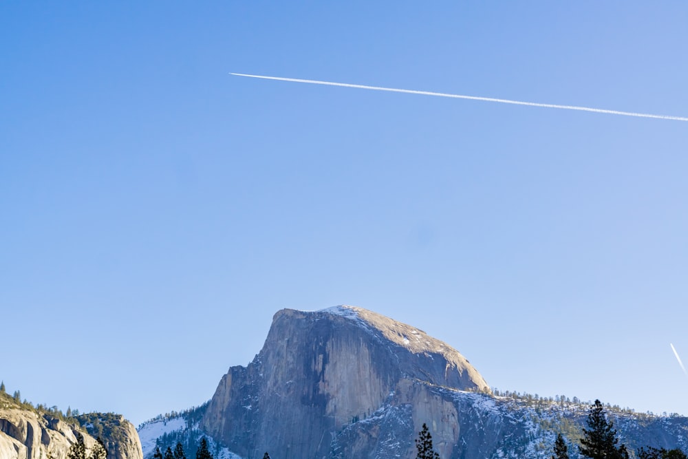 a mountain with a trail of smoke