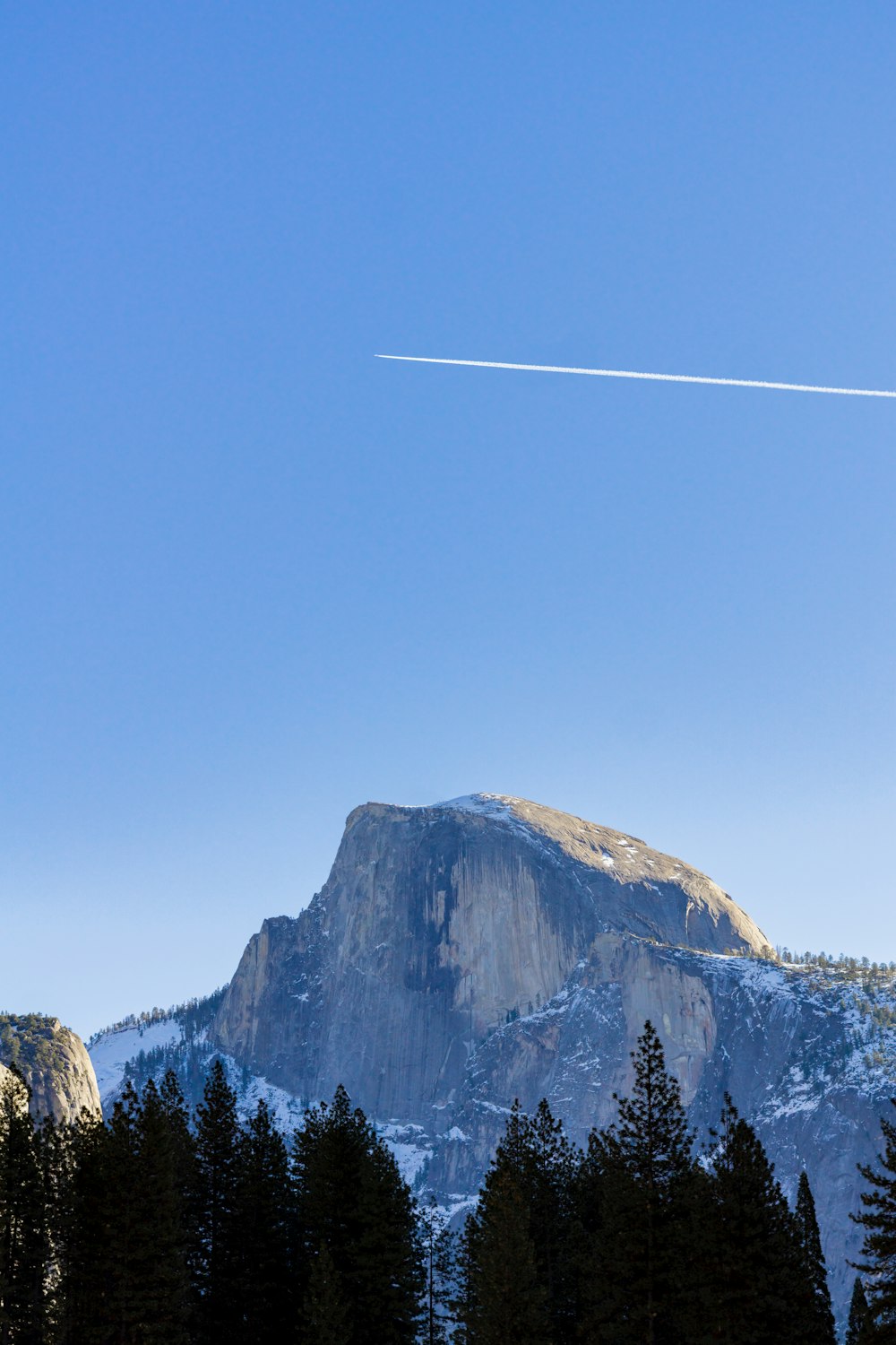 a mountain with a trail of smoke