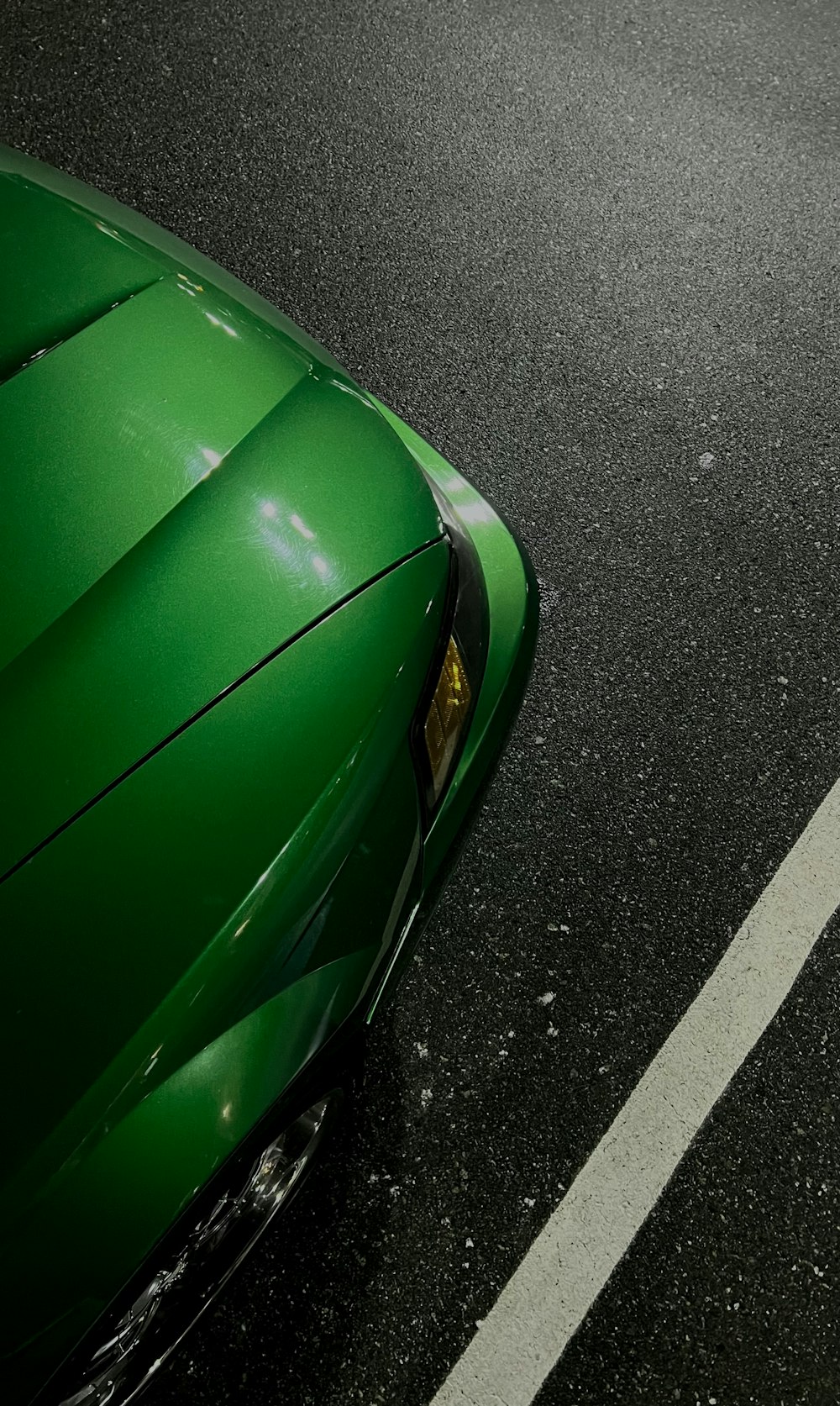 a green boat on a road