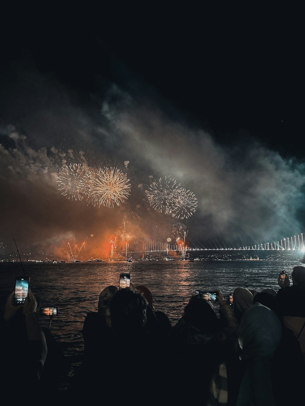 fireworks going off over water