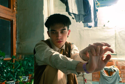 A thoughtful young adult reviewing career options in a bright, colorful workspace.