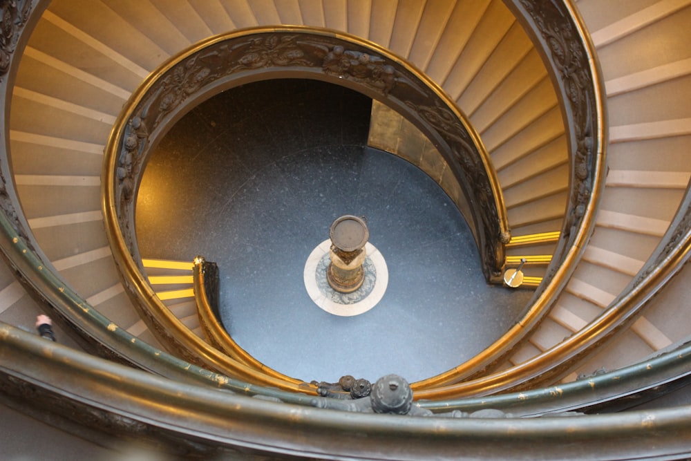 a spiral staircase with a statue