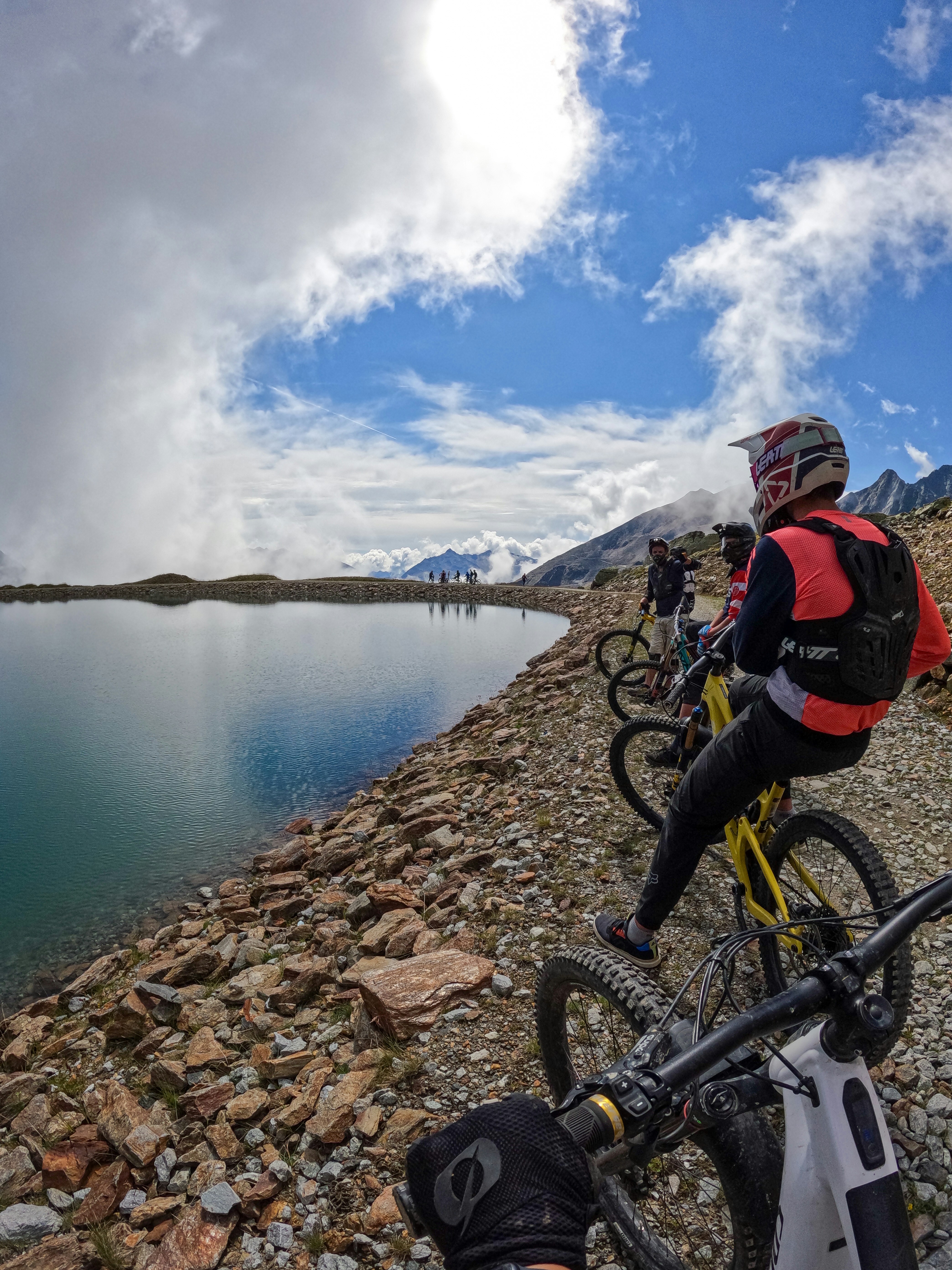 a group of people riding bikes on a rocky shore