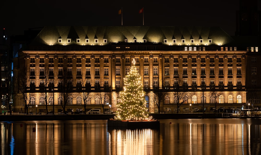 a large building with a christmas tree in front of it