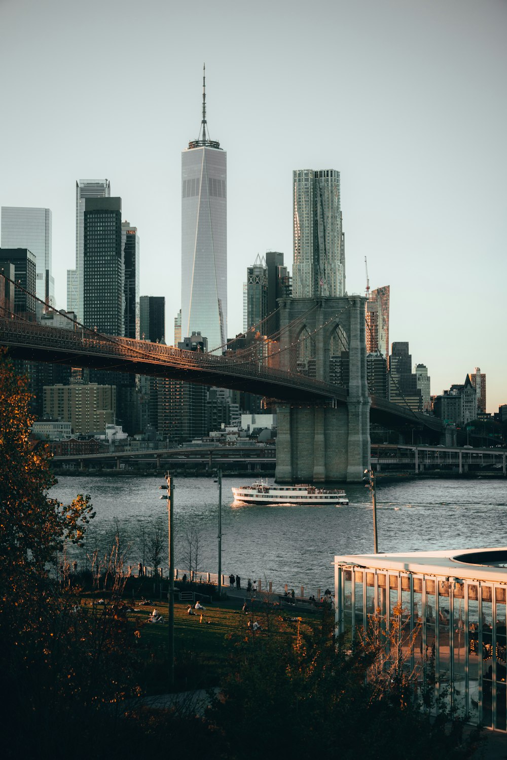 a bridge over a river with a city in the background