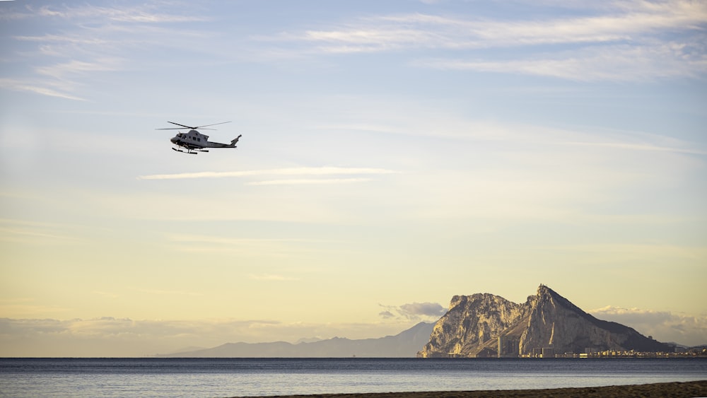 a helicopter flying over water