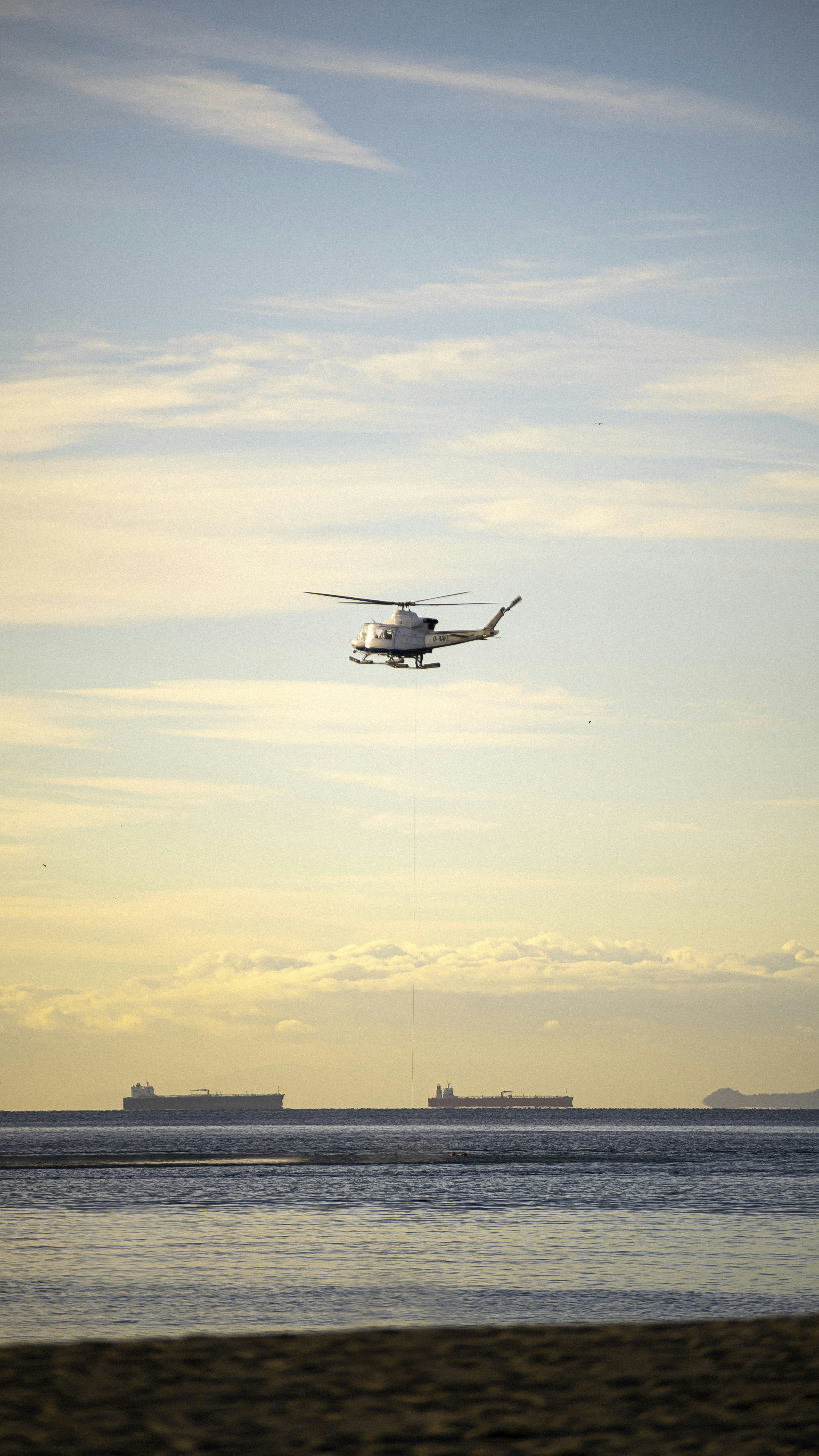 a helicopter flying over the ocean