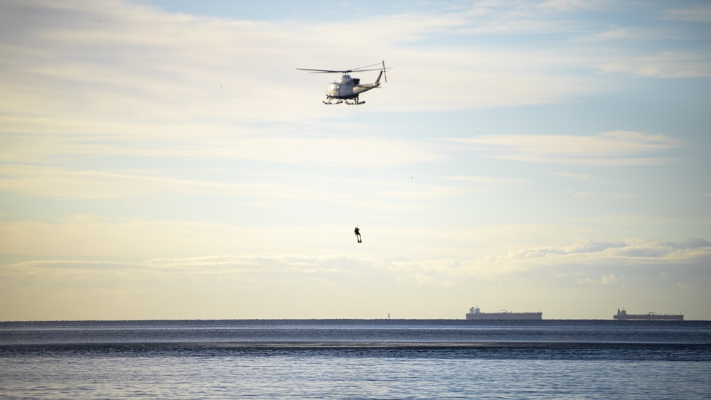 a helicopter flying over a body of water