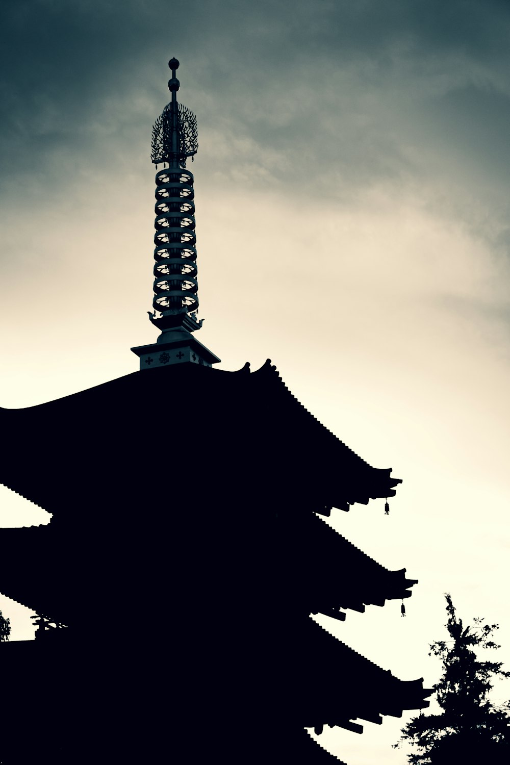 a tall tower with a cloudy sky