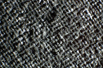 Close-up of textured epoxy surface with a subtle metallic shimmer under bright lighting.