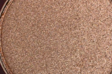Close-up of natural powder brows on a warm beige background.
