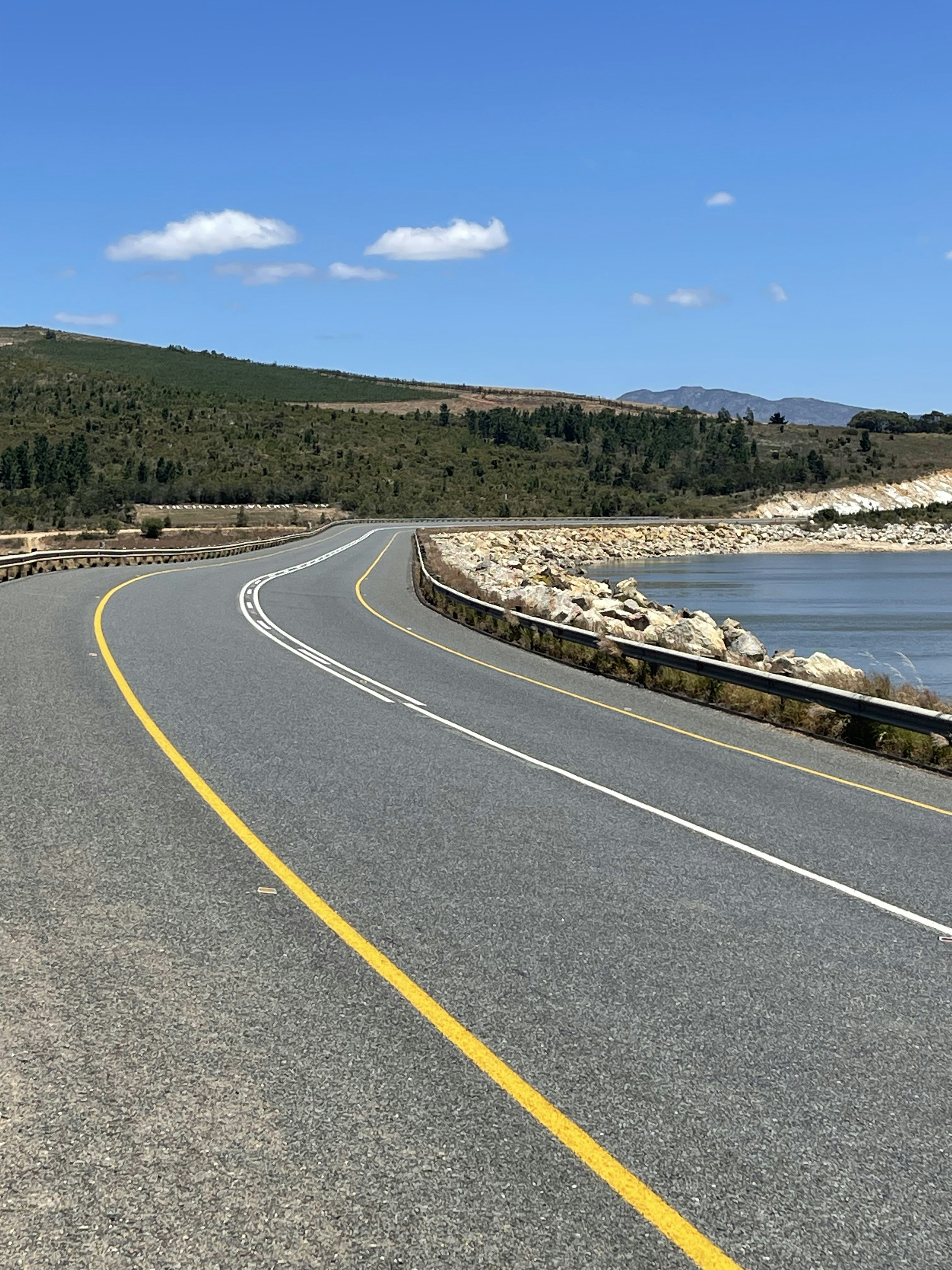 a road next to a body of water