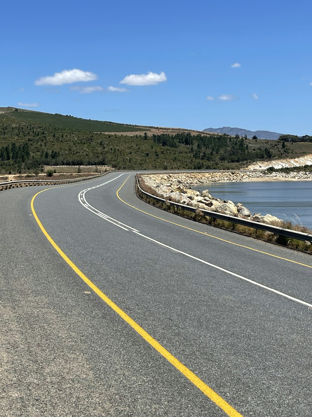 a road next to a body of water