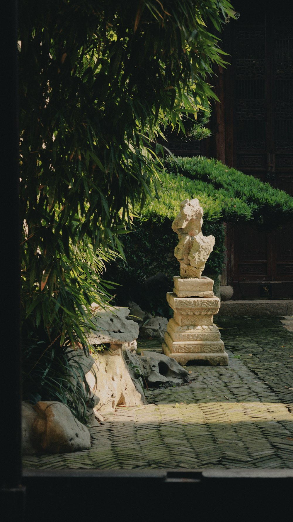 a stone statue on a wooden platform