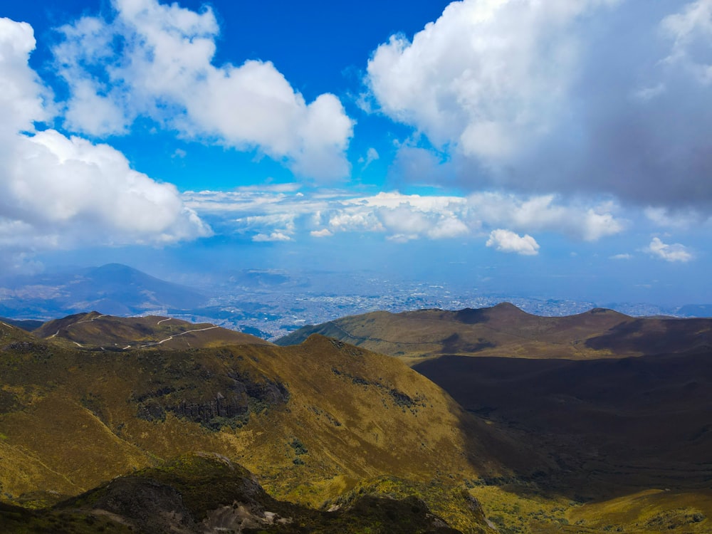 a landscape with hills and clouds