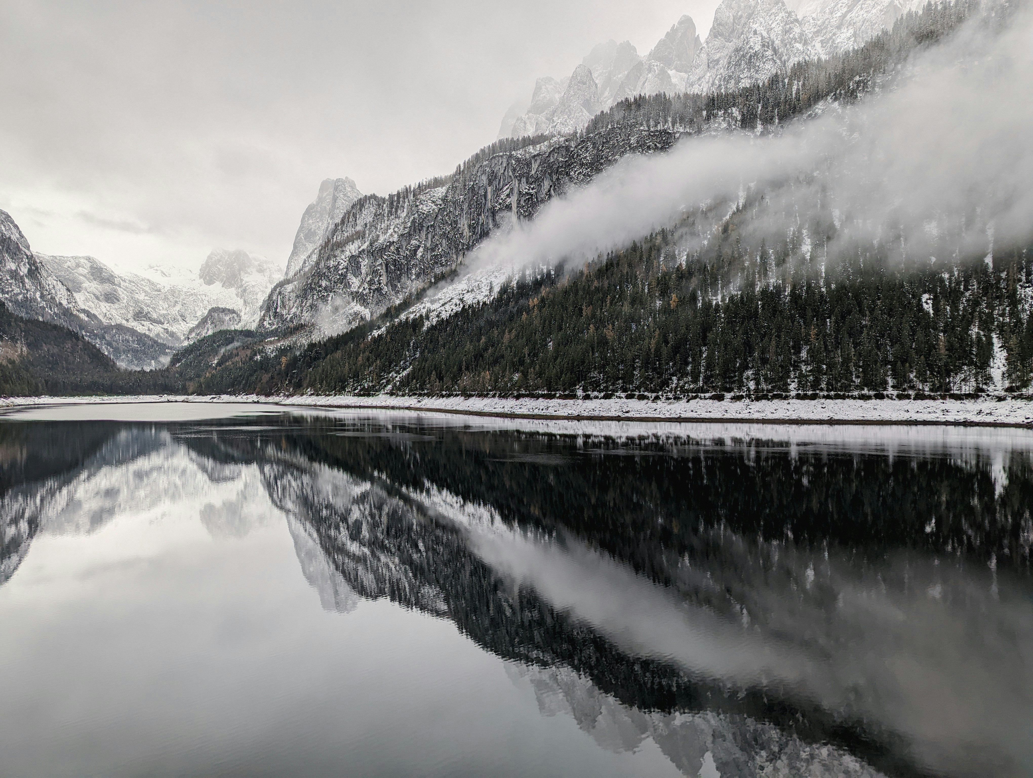a lake with a mountain in the background, Foggy day on Gosausee. Austria 2022