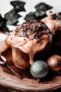 A festive table set with chocolate desserts and decorations in dark brown tones