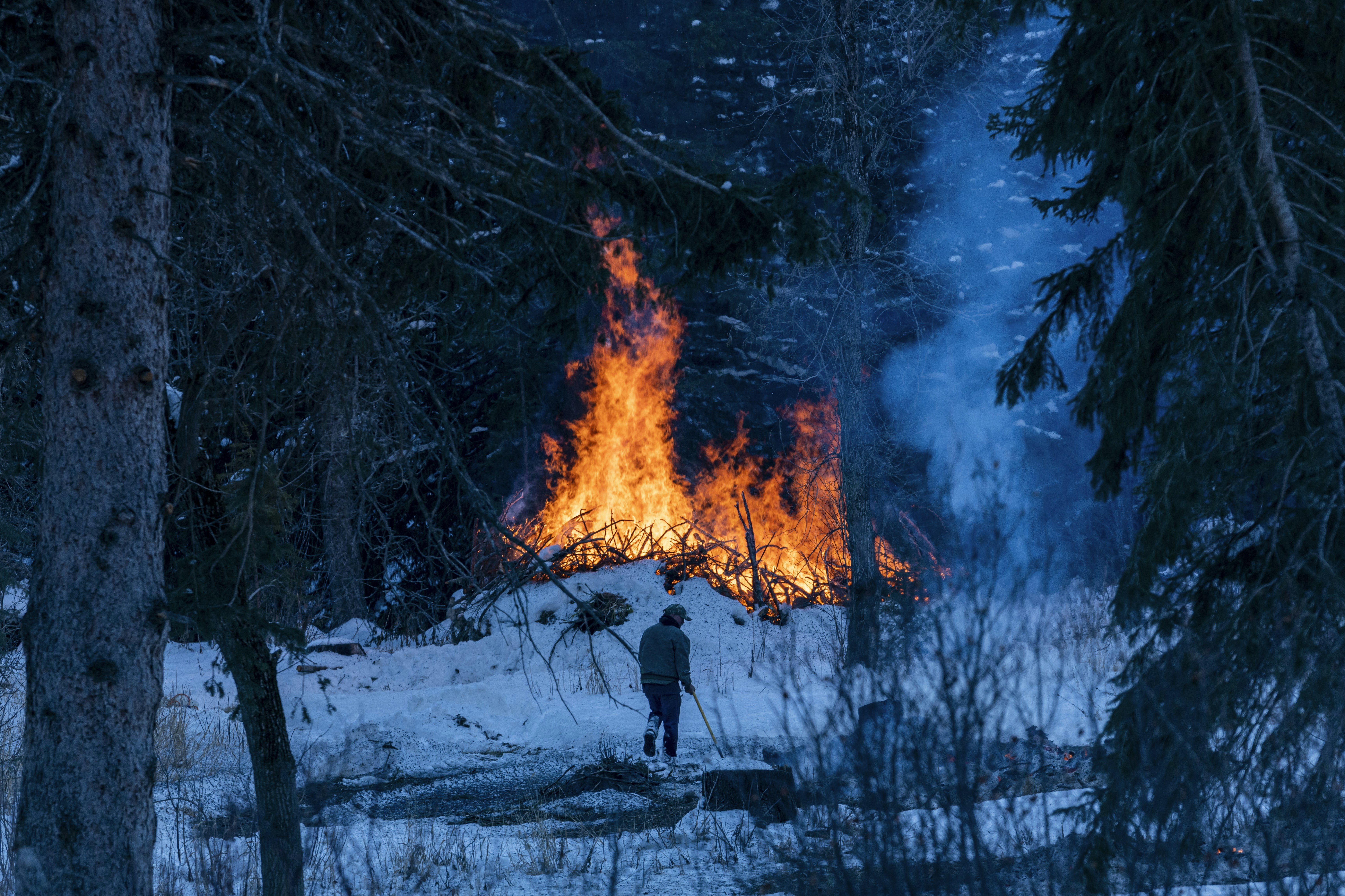 a person standing in front of a large fire