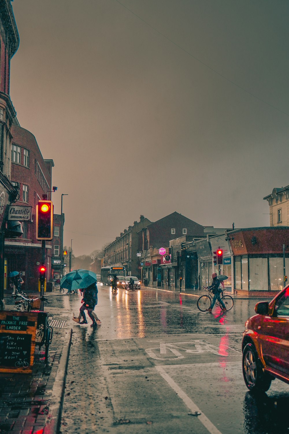 a person walking down a sidewalk with an umbrella