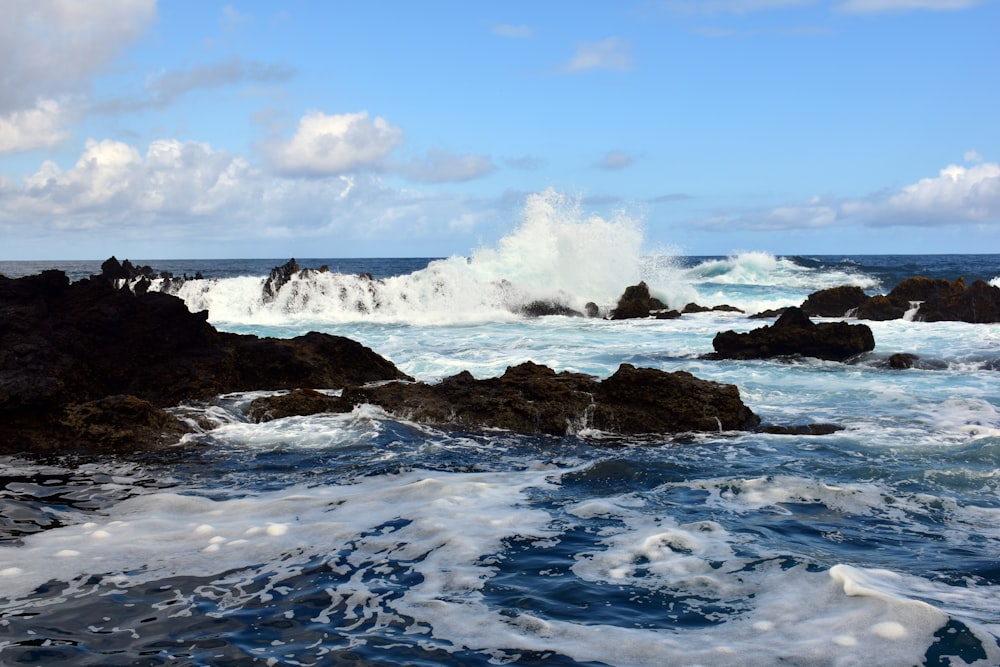 a rocky beach with waves crashing